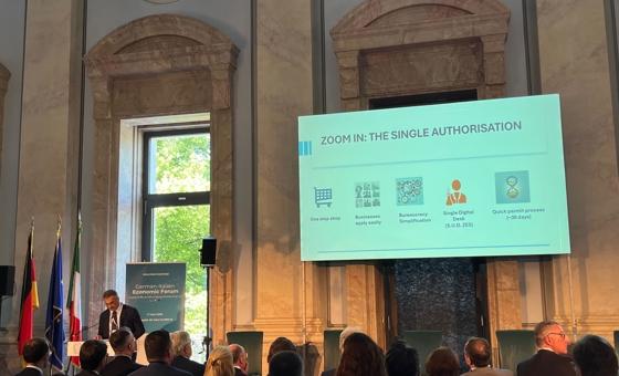 Sala convegno Berlino del 1 luglio 2025 con video su slide Autorizzazione unica